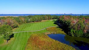 Golf course next to water and trees